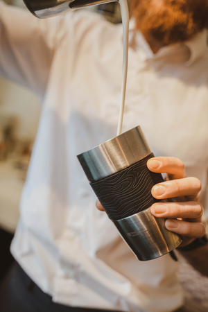 Stainless steel thermos cup with the University of Amsterdam logo